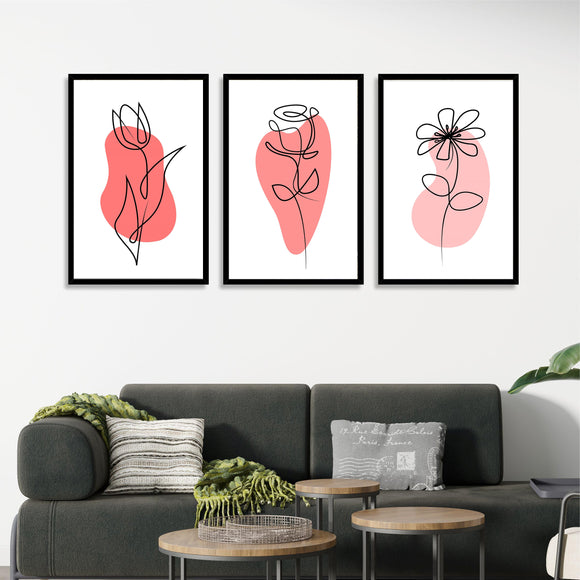 Set of 3 black framed minimalistic line art flower prints with red abstract background above a modern dark gray sofa.