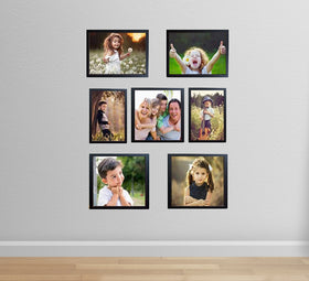 Set of 7 black photo frames arranged in custom wall collage with various sizes displaying family portraits. - Set of 7 - Photo Frames for Wall Collage (8x8inch= 1 frames, 8x10inch= 4, 5x7inch  = 2 ) - Black - Frame World