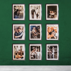 Set of nine 10x12 inch glass front picture frames with custom 7x9 inch prints arranged on a green wall.