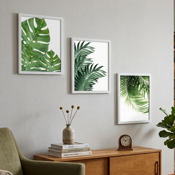 Living room with green armchair, wooden cabinet, and leaf-themed wall art