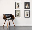 Set of 4 black frames with abstract art collage, arranged in custom wall display above wooden chair. - Set of 4 Abstract Photo Frames - 8x12" / Black - Frame World