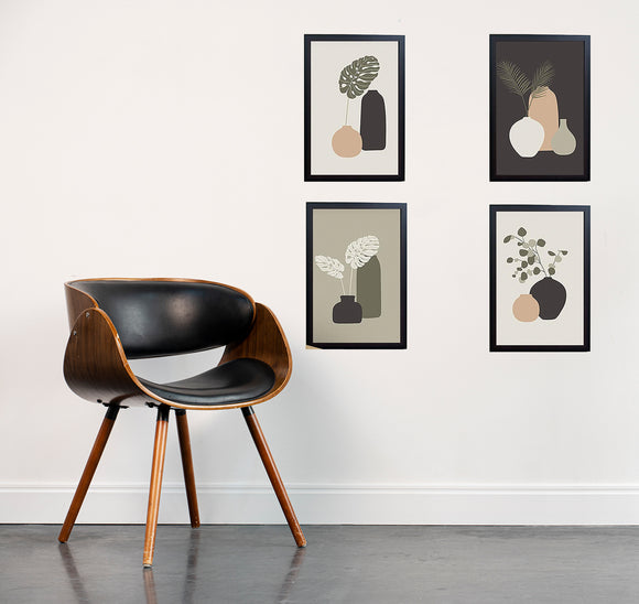 Set of 4 black frames with abstract art collage, arranged in custom wall display above wooden chair. - Set of 4 Abstract Photo Frames - 8x12" / Black - Frame World
