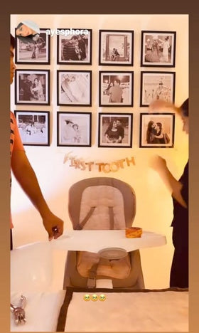 Set of six custom square photo frames arranged in a grid on a wall above a baby high chair.