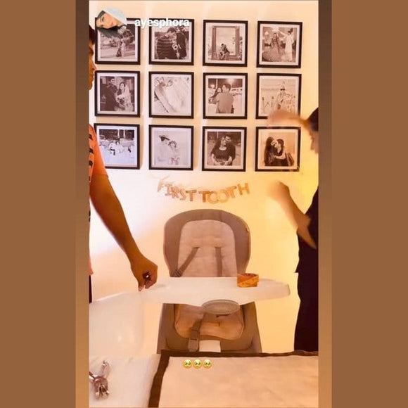 Set of six custom square photo frames arranged in a grid on a wall above a baby high chair.