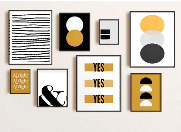 Collection of framed prints on a wall with various designs and text.