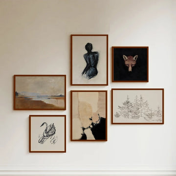Collection of framed artworks on a wall