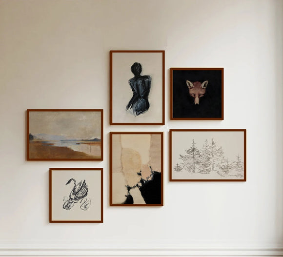 Collection of framed artworks on a wall