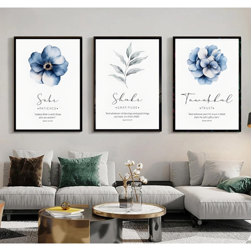 Three framed floral prints above a living room sofa with decorative pillows.