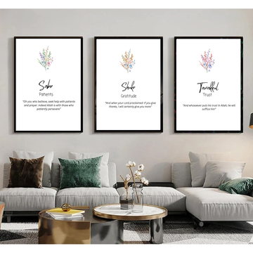 Three framed prints on a wall above a living room sofa with decorative pillows.