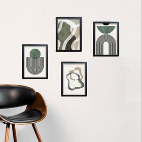Set of 4 black frames with abstract green and beige art collage on white wall above modern wooden chair with black leather. - Set of 4 Abstract Art Frame set - 8x12" / Black - Frame World