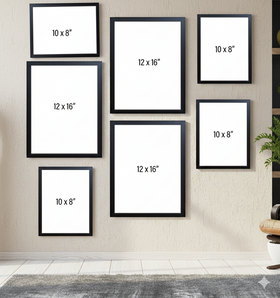 Set of black picture frames with white mats on a wall, displaying various sizes.