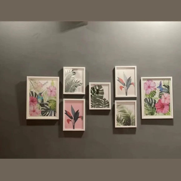 Set of framed botanical prints on a gray wall