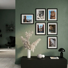 Wall with framed photographs in a modern interior setting