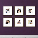 Set of six custom square photo frames arranged in a collage gallery on a purple wall displaying family pictures.