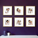 Set of six custom square photo frames displaying family portraits in a stylish collage gallery wall arrangement