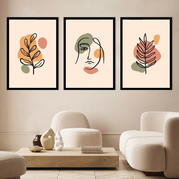A set of three art frames displayed in a living room setting, with abstract art inside each frame. The frames are hung on the wall above a modern style sofa and coffee table.