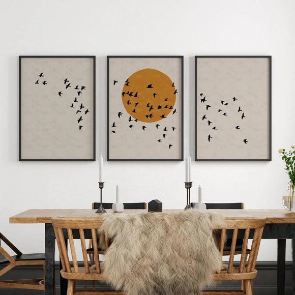 Dining room with wooden table, chairs, and wall art featuring birds and a sun.