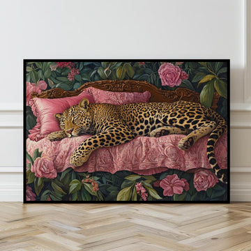 Framed artwork of a leopard on a pink bed with floral and foliage details.