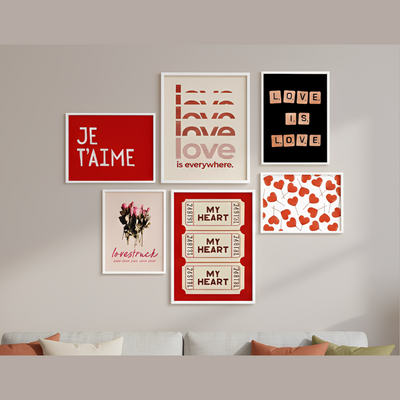 Collection of framed prints on a wall with a sofa in the foreground