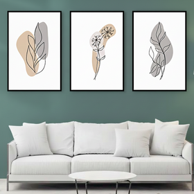 Modern living room with a white sofa and abstract leaf prints on a green wall.