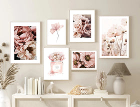 Set of floral prints on a wall above a console table.