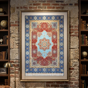A large framed oriental rug with a red, blue, and beige pattern hangs on a rustic brick wall in a study with bookshelves and a desk.